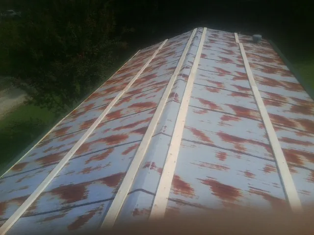 Rusted metal roof panels with new wood purlins before replacement — Storm Damage Roof Repair in Biglerville by Roofing Brothers