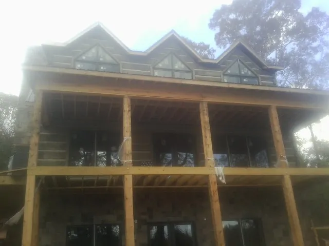 Dormers and porch framing on a large log home under construction in Biglerville